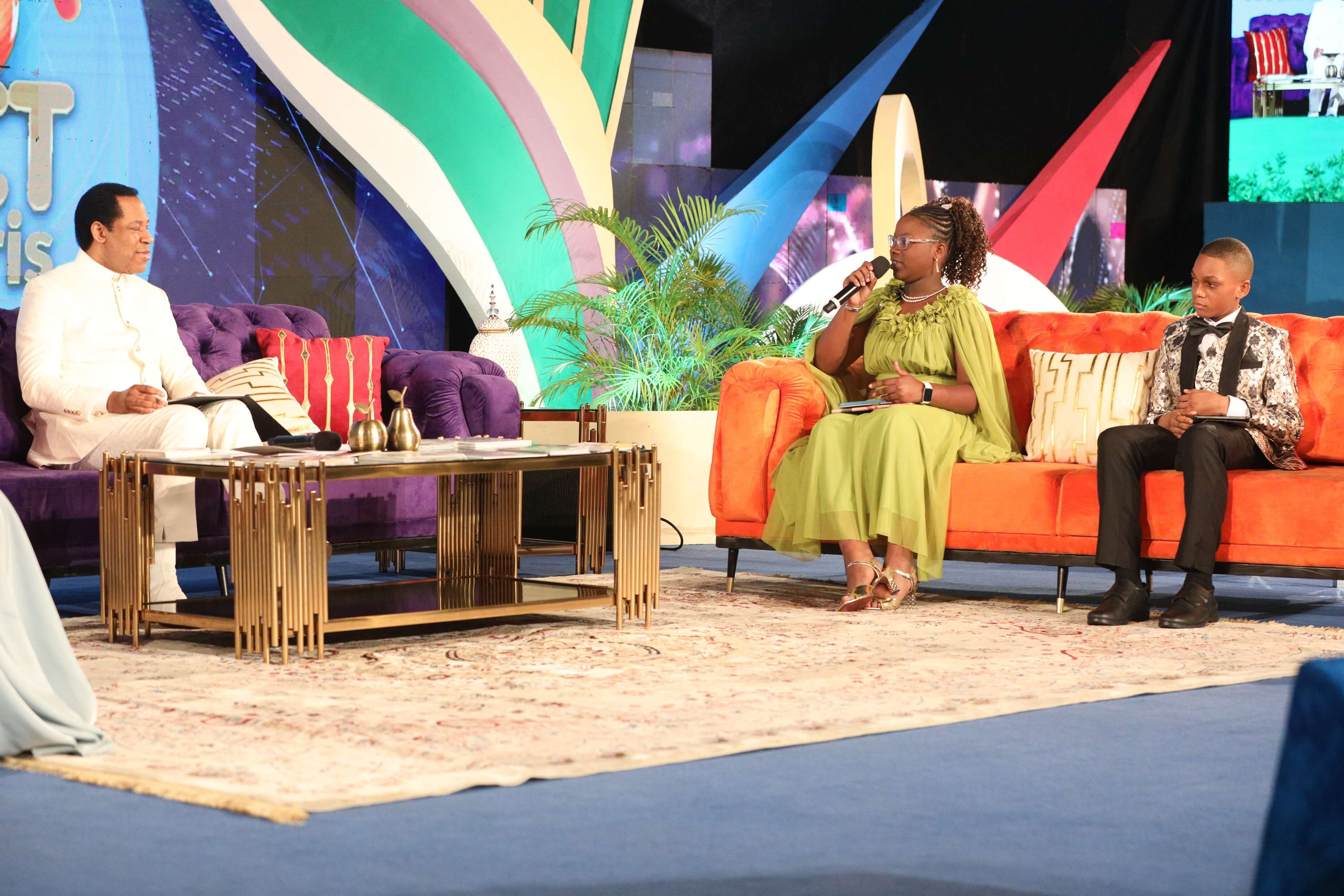 Pastor Chris with children on the GKCPC set