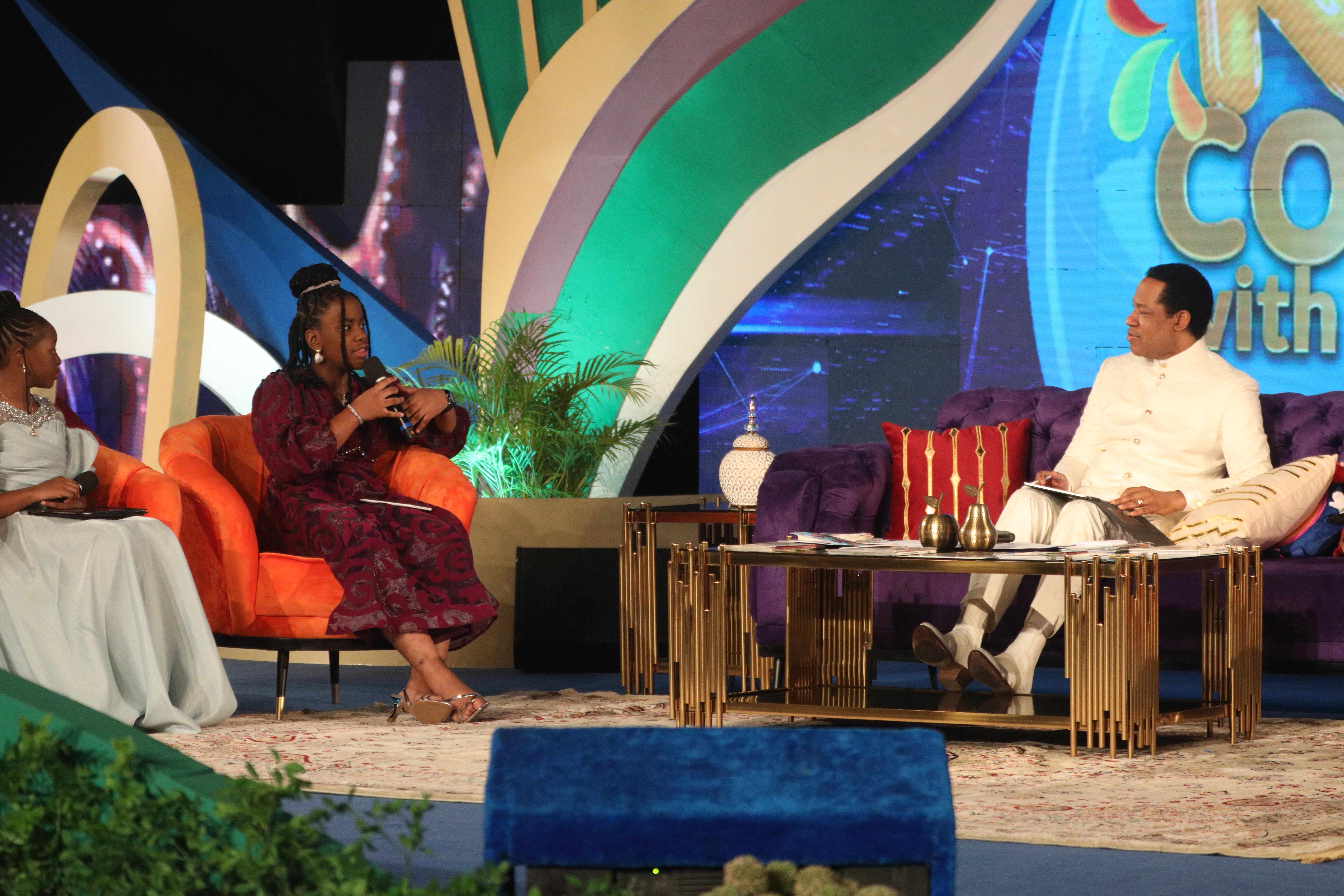 Kids and Pastor Chris on stage at a GKCPC broadcast